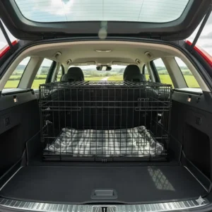A slanted wire dog crate designed to fit safely inside the boot of a British estate car.