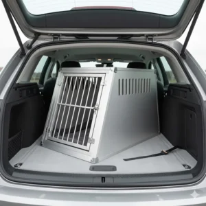 A slanted aluminium dog crate designed to fit securely in the boot of a British estate car or SUV.