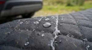 Close-up of water beading on a waterproof dog boot liner to show leak-proof protection for British winters.