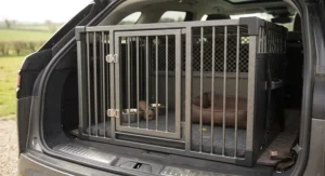 A secure chew proof dog crate placed in a car boot for safe pet transport.