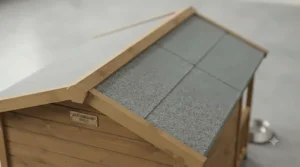 Close-up of the weatherproof felt roof on a sturdy timber dog kennel built to withstand British weather.