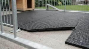 Anti-slip rubber matting laid over a concrete floor dog run to protect canine joints from cold and damp weather