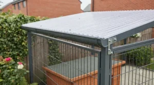 Close-up of a waterproof corrugated roof panel on an outdoor covered dog run protecting against rain.